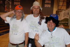 Wellington Landings principal Eric Paul with assistant principals Jim Riley and Damian Milanek find a way to cover their freshly shaved heads after participating in the St. Baldrick's Shave For the Cure event held in the school's gym.